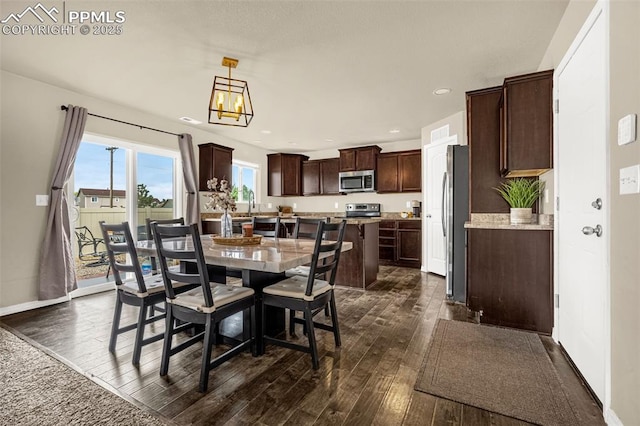 11081 Buckhead Pl, Fountain, CO 80817 - dining space with dark wood-style floors, recessed lighting, and baseboards