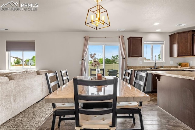 11081 Buckhead Pl, Fountain, CO 80817 - dining area with a chandelier, dark wood finished floors, and recessed lighting