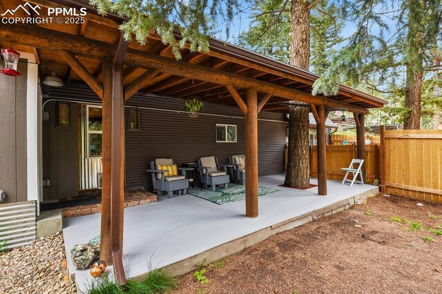 view of patio featuring fence