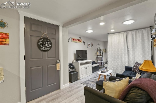 living room featuring light wood-style floors and baseboards