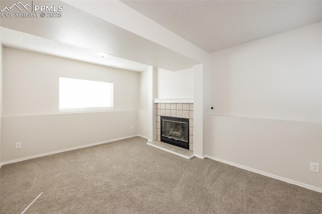 5805 Dutchess Dr, Colorado Springs, CO 80923 - unfurnished living room with carpet, a tiled fireplace, baseboards, and a textured ceiling