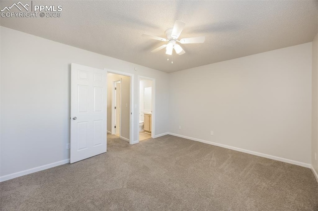 5805 Dutchess Dr, Colorado Springs, CO 80923 - unfurnished bedroom featuring carpet floors, baseboards, a textured ceiling, ensuite bath, and a ceiling fan
