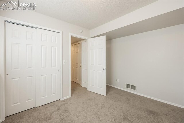 5805 Dutchess Dr, Colorado Springs, CO 80923 - unfurnished bedroom with carpet floors, baseboards, a closet, and a textured ceiling