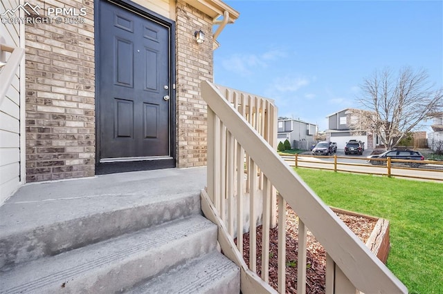 5805 Dutchess Dr, Colorado Springs, CO 80923 - entrance to property featuring a yard, brick siding, and a residential view