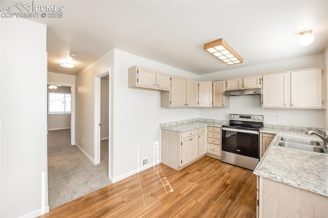 5805 Dutchess Dr, Colorado Springs, CO 80923 - kitchen featuring stainless steel electric range oven, a sink, light wood-style flooring, and baseboards