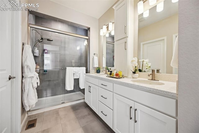5932 Torrisdale Vw, Colorado Springs, CO 80927 - bathroom with a stall shower, double vanity, and tile patterned flooring