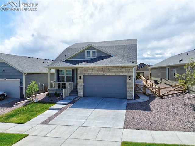 5932 Torrisdale Vw, Colorado Springs, CO 80927 - view of front of home featuring stone siding, a garage, concrete driveway, roof with shingles, and fence
