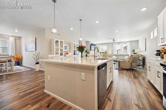 5932 Torrisdale Vw, Colorado Springs, CO 80927 - kitchen with a sink, stainless steel dishwasher, open floor plan, dark wood-type flooring, and a center island with sink