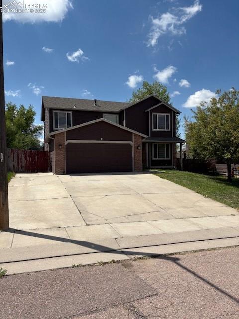 905 Hubbell Dr, Colorado Springs, CO 80911 - traditional-style house with an attached garage, driveway, and brick siding