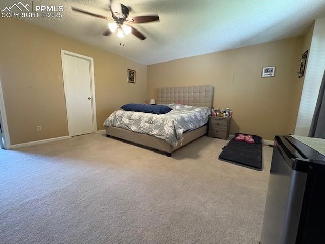 905 Hubbell Dr, Colorado Springs, CO 80911 - carpeted bedroom featuring a ceiling fan, baseboards, and a textured ceiling