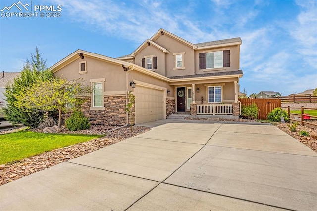 10282 Mt Lincoln Dr, Peyton, CO 80831 - view of front facade with stucco siding, covered porch, fence, stone siding, and driveway