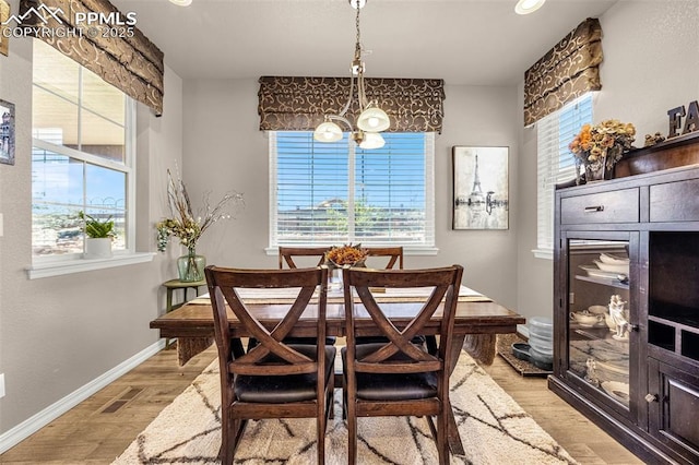 10282 Mt Lincoln Dr, Peyton, CO 80831 - dining space featuring light wood-type flooring, a chandelier, and baseboards