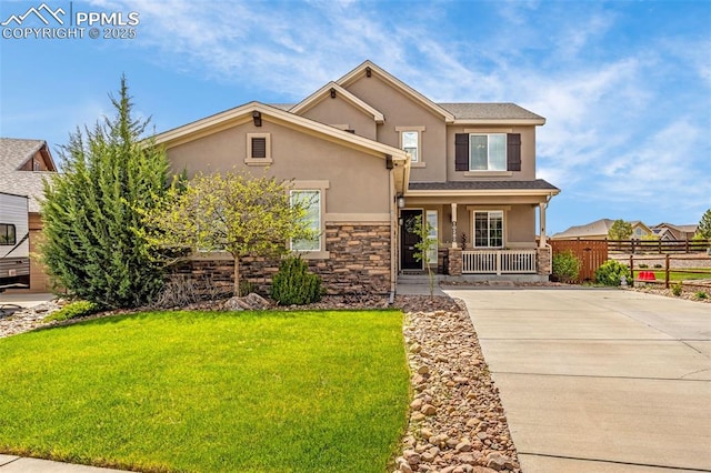10282 Mt Lincoln Dr, Peyton, CO 80831 - view of front facade featuring a porch, stucco siding, concrete driveway, and stone siding