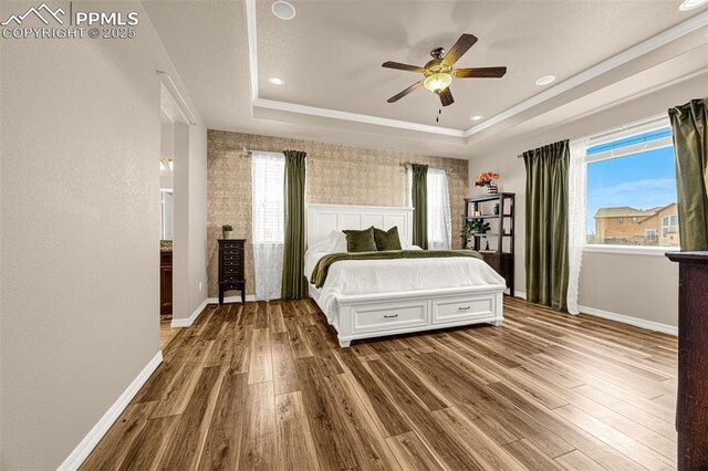 10282 Mt Lincoln Dr, Peyton, CO 80831 - bedroom with wood finished floors, a tray ceiling, baseboards, recessed lighting, and ceiling fan