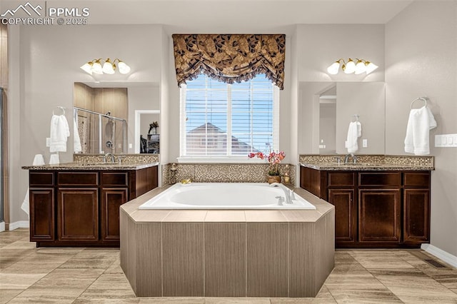 10282 Mt Lincoln Dr, Peyton, CO 80831 - bathroom with a shower stall, a garden tub, two vanities, and tile patterned floors