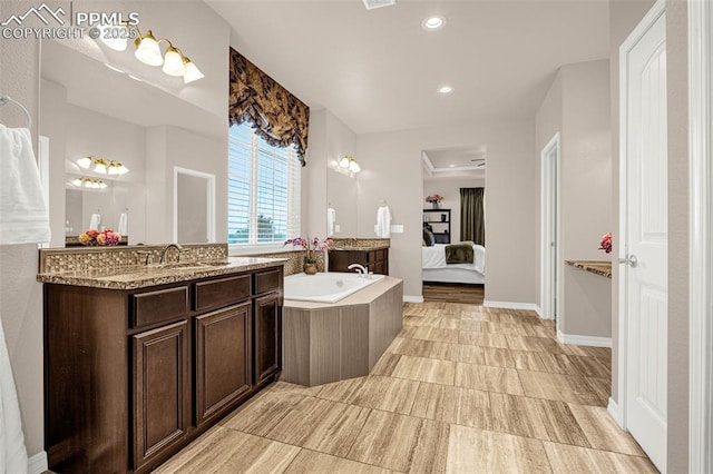 10282 Mt Lincoln Dr, Peyton, CO 80831 - ensuite bathroom featuring recessed lighting, a bath, vanity, and baseboards