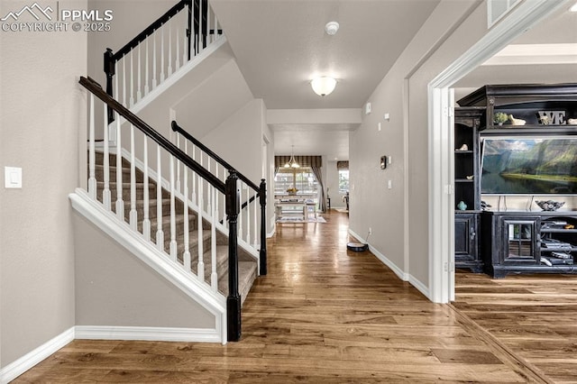 10282 Mt Lincoln Dr, Peyton, CO 80831 - foyer featuring wood finished floors, stairway, baseboards, and a chandelier