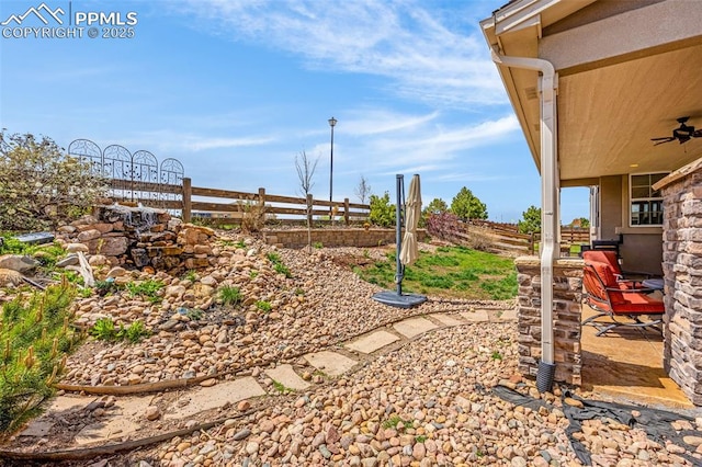 10282 Mt Lincoln Dr, Peyton, CO 80831 - view of yard featuring fence, a ceiling fan, and a patio area