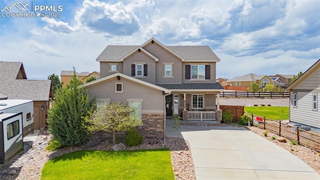 10282 Mt Lincoln Dr, Peyton, CO 80831 - view of front of property with stucco siding, a porch, stone siding, a residential view, and concrete driveway