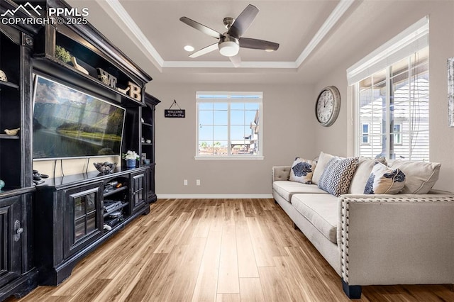 10282 Mt Lincoln Dr, Peyton, CO 80831 - living room with a tray ceiling, a ceiling fan, wood finished floors, ornamental molding, and baseboards
