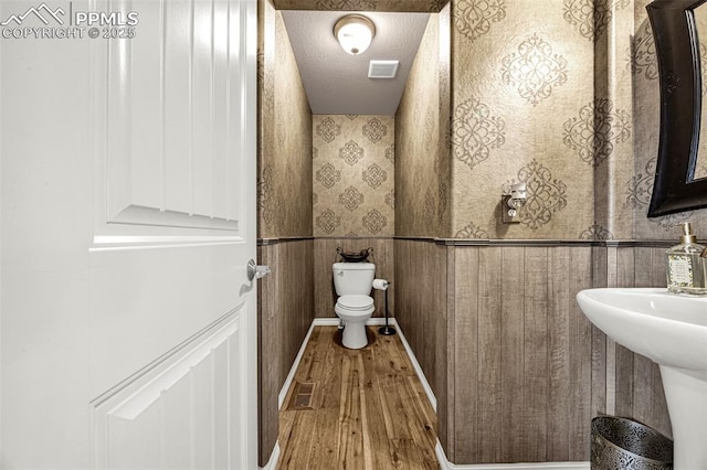 10282 Mt Lincoln Dr, Peyton, CO 80831 - half bathroom featuring toilet, hardwood / wood-style floors, and a sink