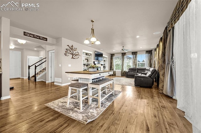 10282 Mt Lincoln Dr, Peyton, CO 80831 - dining area with stairs, wood finished floors, baseboards, ceiling fan, and a chandelier