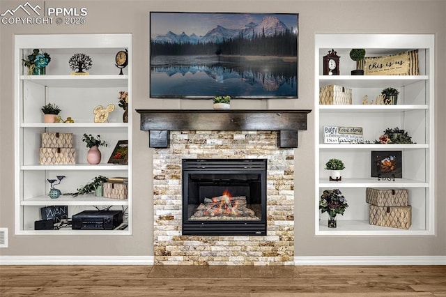 10282 Mt Lincoln Dr, Peyton, CO 80831 - unfurnished living room with wood finished floors, a fireplace, and built in features