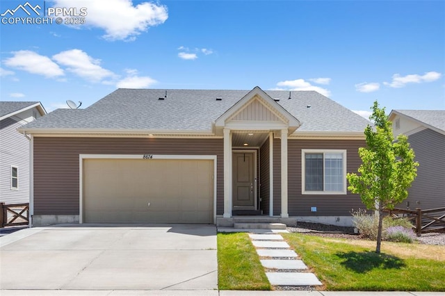 8674 Tranquil Knoll Ln, Colorado Springs, CO 80927 - view of front of home with a garage, concrete driveway, and a shingled roof
