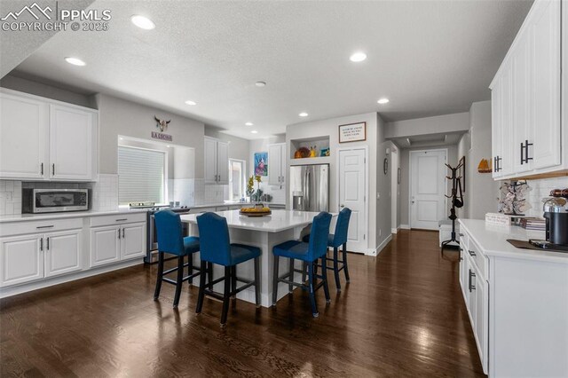 8674 Tranquil Knoll Ln, Colorado Springs, CO 80927 - dining room featuring recessed lighting, dark wood finished floors, a textured ceiling, and baseboards