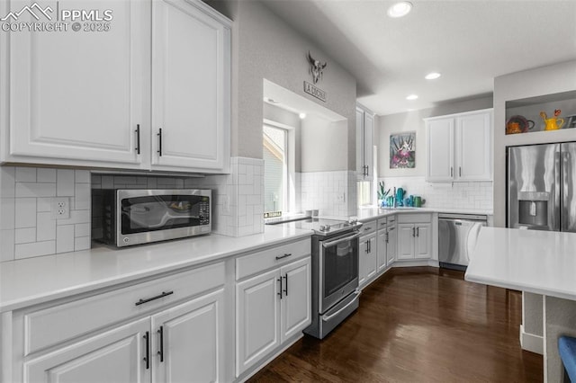 8674 Tranquil Knoll Ln, Colorado Springs, CO 80927 - kitchen featuring appliances with stainless steel finishes, white cabinets, decorative backsplash, light countertops, and a sink