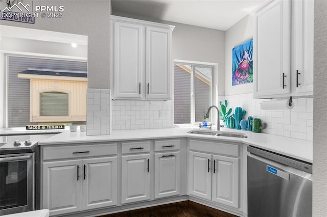 8674 Tranquil Knoll Ln, Colorado Springs, CO 80927 - kitchen with appliances with stainless steel finishes, a sink, white cabinets, tasteful backsplash, and light countertops