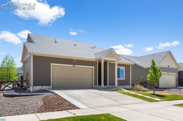 8674 Tranquil Knoll Ln, Colorado Springs, CO 80927 - view of front of house featuring driveway, an attached garage, and roof with shingles