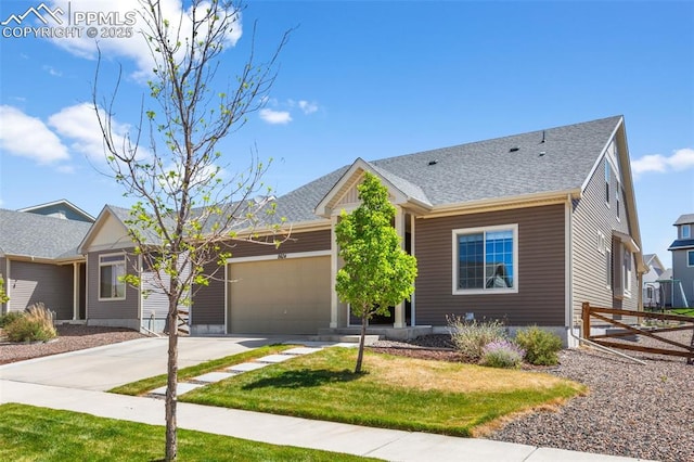8674 Tranquil Knoll Ln, Colorado Springs, CO 80927 - view of front of home with an attached garage, concrete driveway, a front yard, and a shingled roof