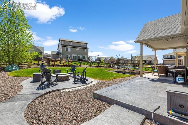 8674 Tranquil Knoll Ln, Colorado Springs, CO 80927 - view of patio with a fire pit, a trampoline, and a residential view