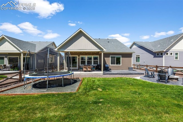 8674 Tranquil Knoll Ln, Colorado Springs, CO 80927 - rear view of property with a trampoline, a patio, and board and batten siding
