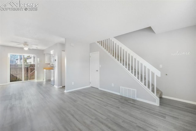 1223 Soaring Eagle Dr, Colorado Springs, CO 80915 - unfurnished living room featuring stairs, wood finished floors, baseboards, and a ceiling fan