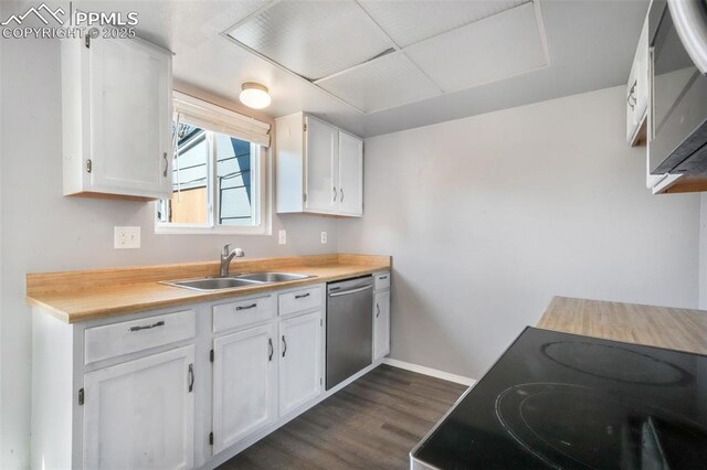 1223 Soaring Eagle Dr, Colorado Springs, CO 80915 - kitchen with stainless steel appliances, a sink, dark wood-style floors, white cabinets, and baseboards