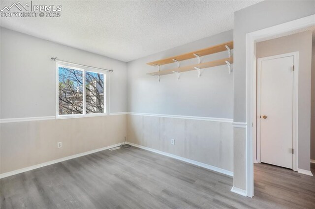 1223 Soaring Eagle Dr, Colorado Springs, CO 80915 - unfurnished room featuring wood finished floors, a textured ceiling, and baseboards