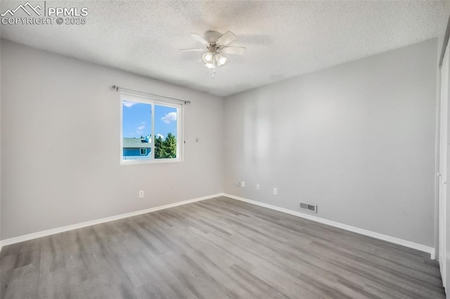 1223 Soaring Eagle Dr, Colorado Springs, CO 80915 - empty room with wood finished floors, ceiling fan, a textured ceiling, and baseboards