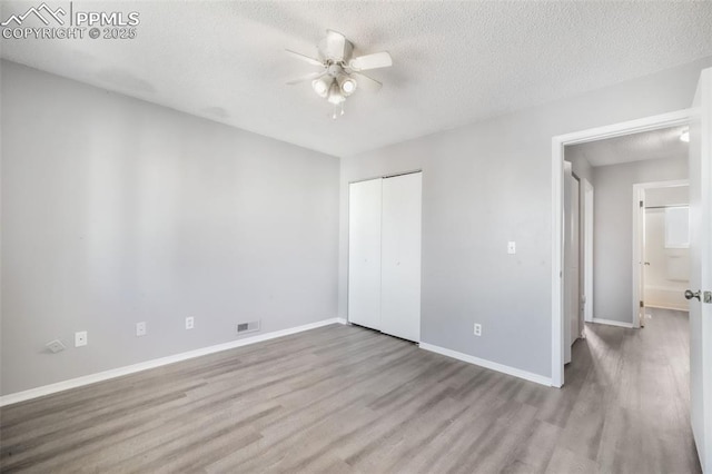 1223 Soaring Eagle Dr, Colorado Springs, CO 80915 - unfurnished bedroom with wood finished floors, a textured ceiling, a closet, baseboards, and a ceiling fan
