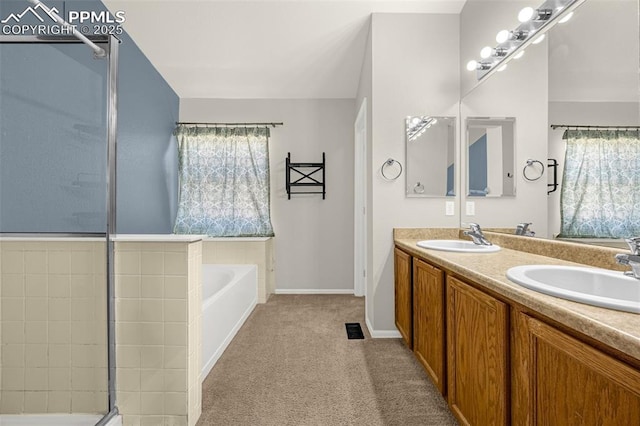 8290 Meadowcrest Dr, Fountain, CO 80817 - full bath with a garden tub, double vanity, baseboards, and a shower with door