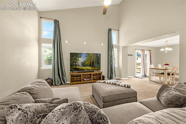 8290 Meadowcrest Dr, Fountain, CO 80817 - carpeted living room with high vaulted ceiling, a chandelier, plenty of natural light, a ceiling fan, and baseboards