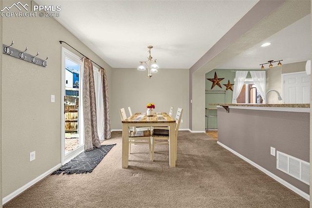 8290 Meadowcrest Dr, Fountain, CO 80817 - carpeted dining area with a chandelier and baseboards