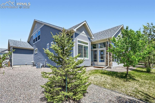 7225 Horizon Wood Ln, Colorado Springs, CO 80927 - back of house featuring a yard, a sunroom, and a shingled roof