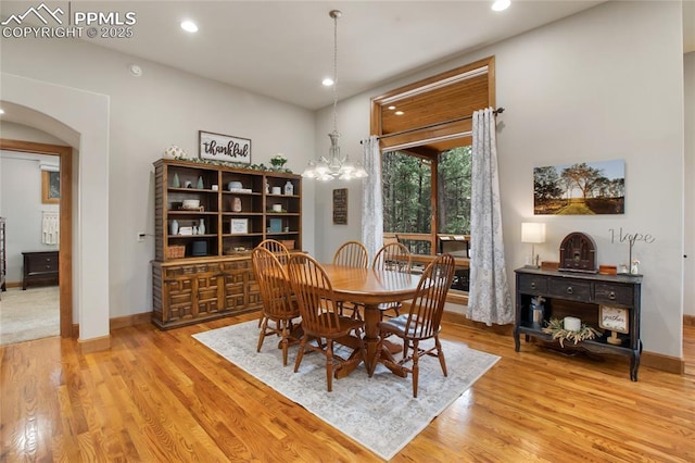 1230 Cottontail Trl, Woodland Park, CO 80863 - dining space with arched walkways, light wood-type flooring, recessed lighting, baseboards, and a chandelier