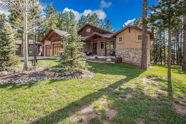 1230 Cottontail Trl, Woodland Park, CO 80863 - view of front of house with stone siding, a garage, stucco siding, and a front yard