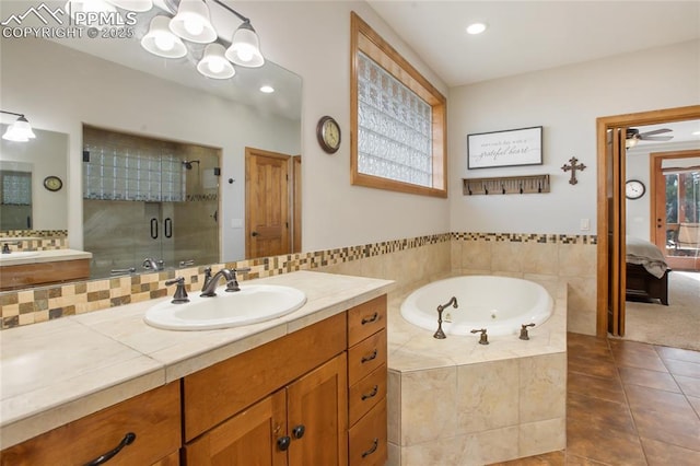 1230 Cottontail Trl, Woodland Park, CO 80863 - ensuite bathroom with a shower stall, a jetted tub, tile patterned flooring, ceiling fan, and vanity