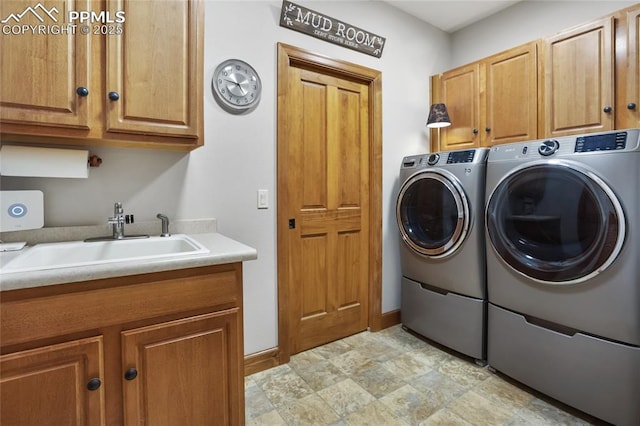 1230 Cottontail Trl, Woodland Park, CO 80863 - clothes washing area featuring washing machine and clothes dryer, cabinet space, and baseboards