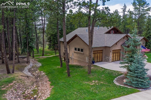 1230 Cottontail Trl, Woodland Park, CO 80863 - view of front facade with stucco siding, driveway, a shingled roof, a garage, and a front yard