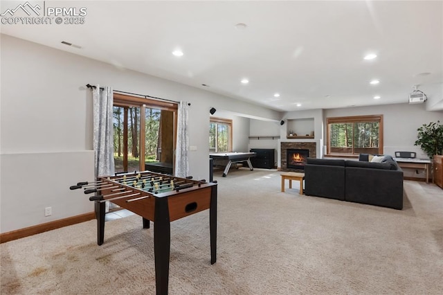 1230 Cottontail Trl, Woodland Park, CO 80863 - playroom featuring light colored carpet, healthy amount of natural light, recessed lighting, a lit fireplace, and baseboards